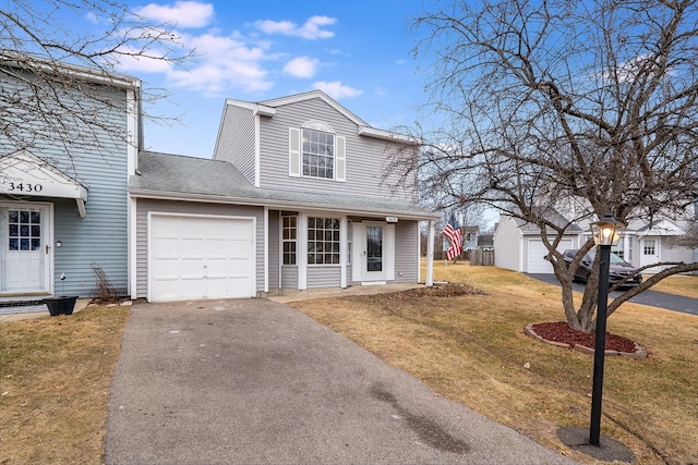 front facade featuring a garage and a front yard