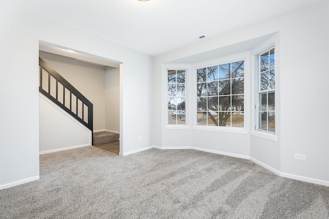 spare room with a healthy amount of sunlight and carpet