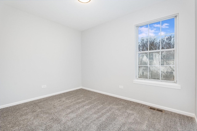 carpeted spare room featuring a healthy amount of sunlight