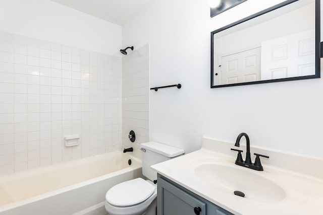 full bathroom featuring vanity, tiled shower / bath combo, and toilet