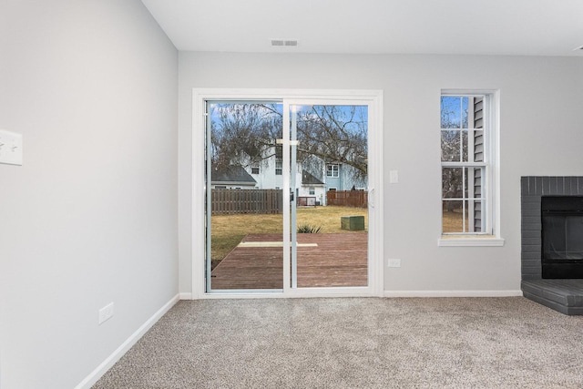 unfurnished living room featuring carpet floors and a fireplace