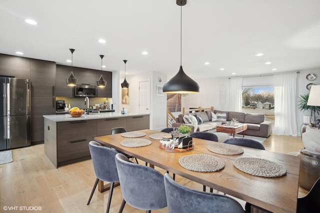 dining area with sink and light hardwood / wood-style flooring