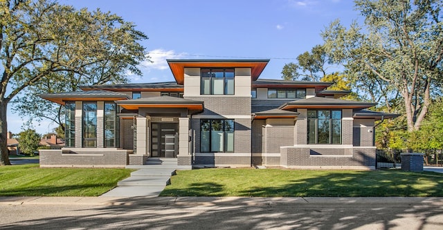 view of front of property with brick siding and a front lawn