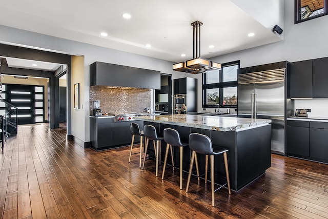 6505 N Knox Ave, Lincolnwood, IL 60645 - kitchen featuring stainless steel appliances, a center island, dark cabinetry, and modern cabinets