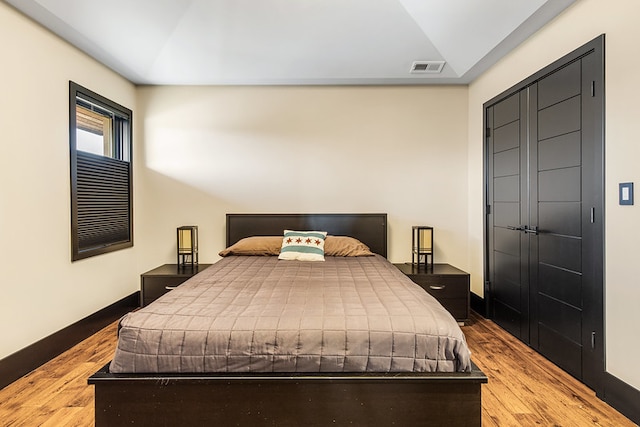 6505 N Knox Ave, Lincolnwood, IL 60645 - bedroom with baseboards, visible vents, and wood finished floors