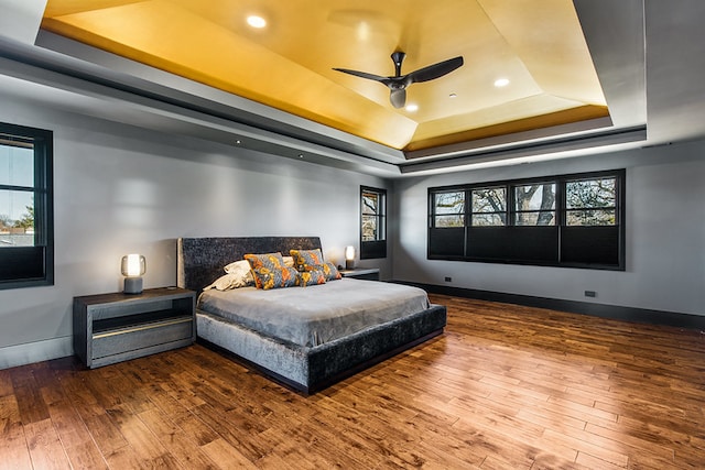 6505 N Knox Ave, Lincolnwood, IL 60645 - bedroom with recessed lighting, a raised ceiling, hardwood / wood-style flooring, and baseboards