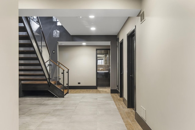 6505 N Knox Ave, Lincolnwood, IL 60645 - corridor with stairway, baseboards, and visible vents