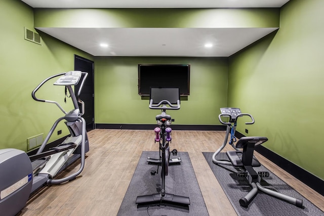 6505 N Knox Ave, Lincolnwood, IL 60645 - workout room featuring baseboards, visible vents, and wood finished floors