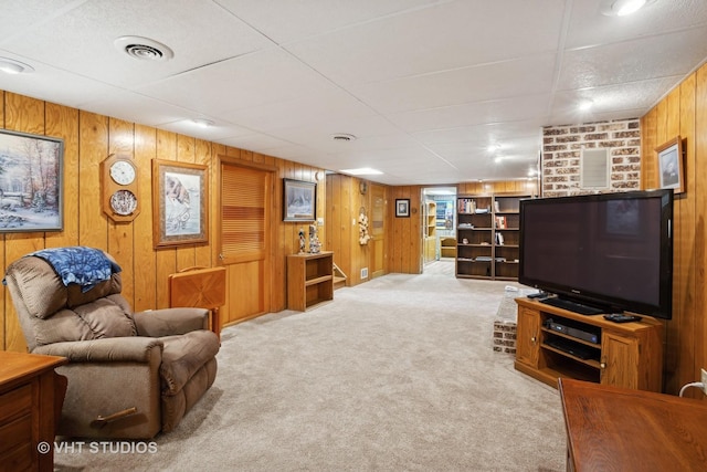 living room with wooden walls and light colored carpet