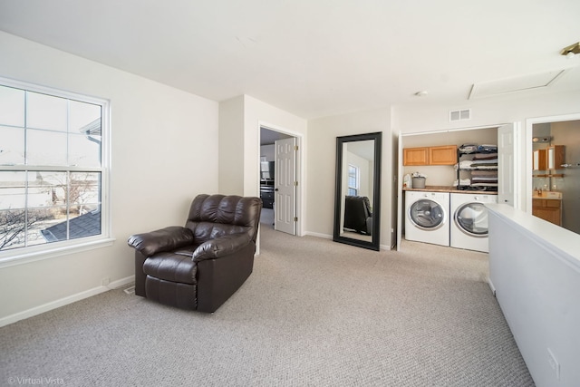 sitting room with light colored carpet and washing machine and clothes dryer