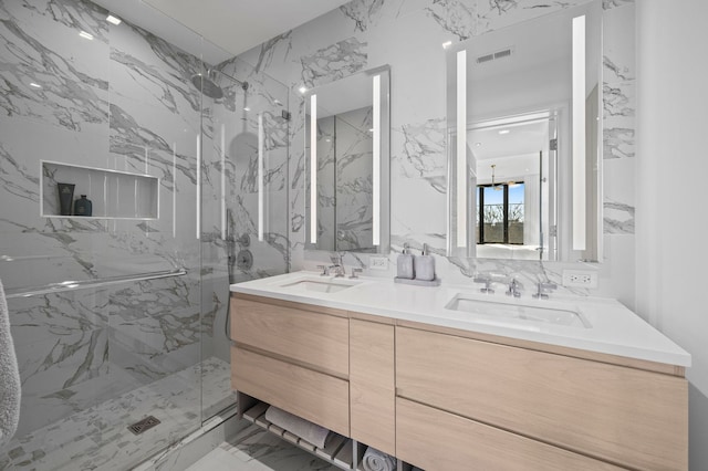 full bathroom with visible vents, a sink, a marble finish shower, and stone wall