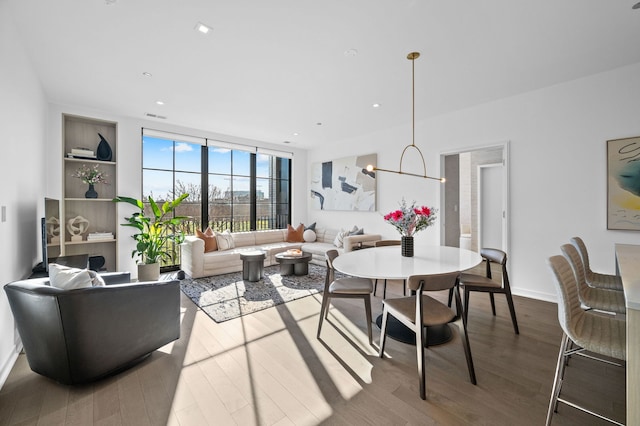 dining room with floor to ceiling windows, recessed lighting, visible vents, an inviting chandelier, and wood finished floors