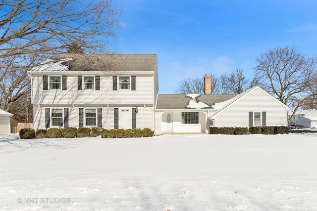 colonial home featuring a chimney