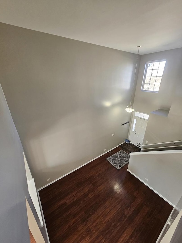 interior space with baseboards and wood finished floors