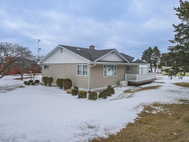 view of front of house featuring a shingled roof and a chimney