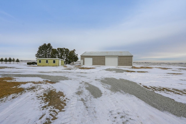 exterior space with an outbuilding and a detached garage