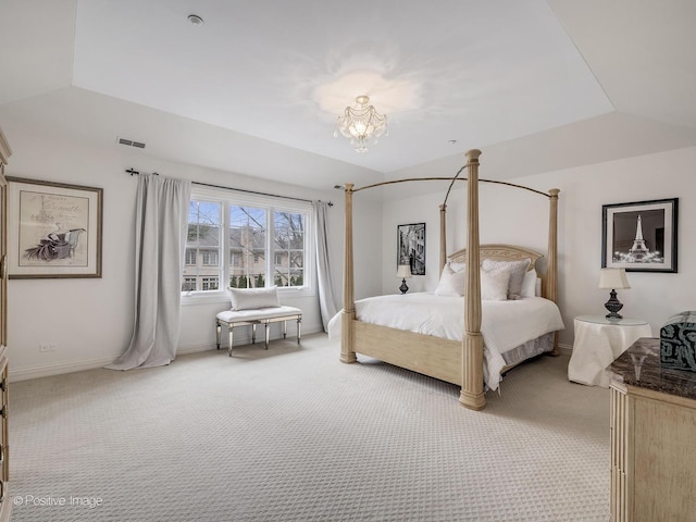 carpeted bedroom featuring lofted ceiling, a raised ceiling, and a notable chandelier