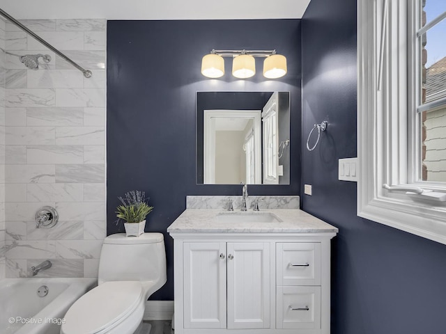 full bathroom featuring tiled shower / bath combo, vanity, and toilet