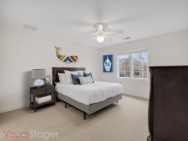 bedroom with ceiling fan and light carpet