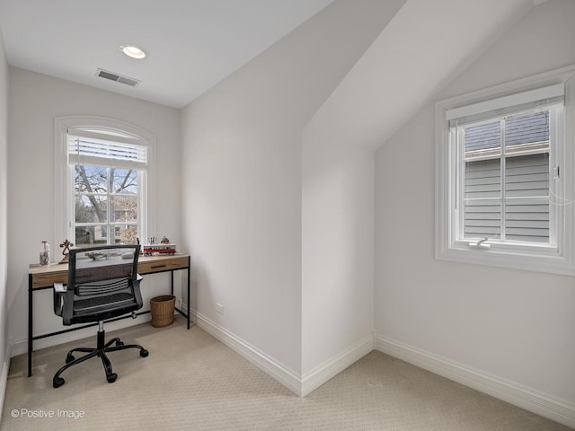 carpeted home office featuring vaulted ceiling