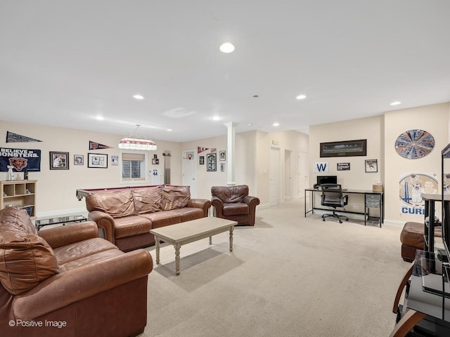 living room featuring light carpet and decorative columns