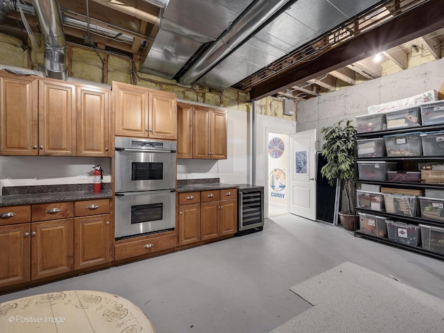 kitchen featuring beverage cooler and stainless steel double oven