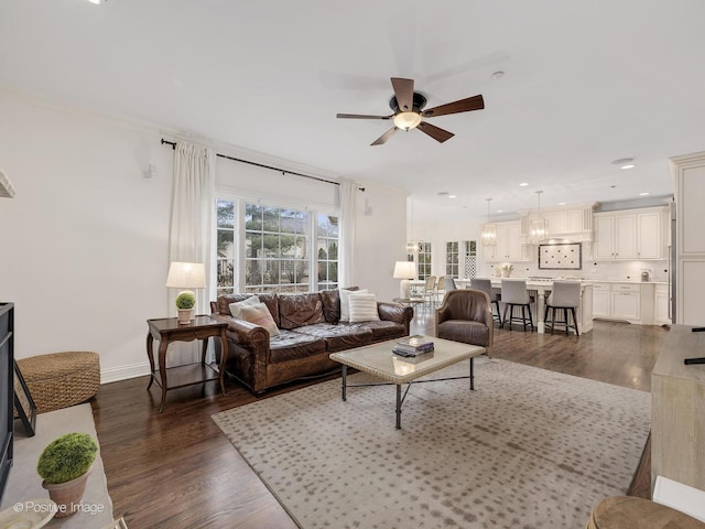 living room featuring ornamental molding, dark hardwood / wood-style floors, and ceiling fan