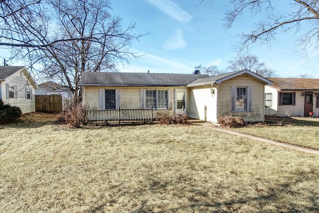 ranch-style house featuring a wooden deck and a front lawn