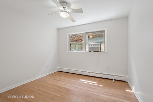empty room featuring baseboard heating, cooling unit, light wood-style flooring, ceiling fan, and baseboards