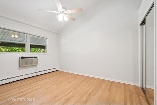 unfurnished bedroom featuring baseboard heating, light wood-style floors, a closet, a wall mounted air conditioner, and baseboards