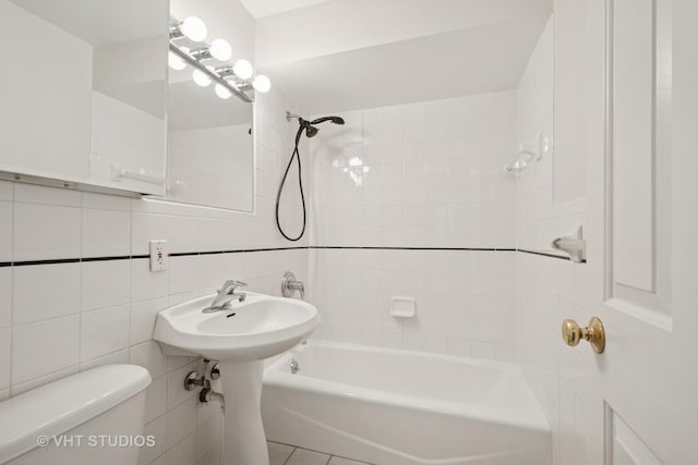 full bathroom with toilet, bathtub / shower combination, and tile walls