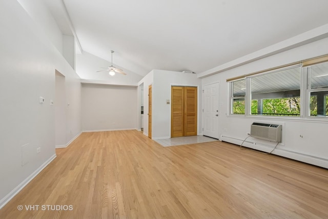 unfurnished room with a wall unit AC, light wood finished floors, a ceiling fan, a baseboard heating unit, and lofted ceiling