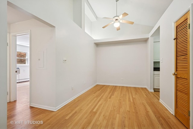 bonus room featuring a baseboard radiator, a ceiling fan, light wood-style flooring, baseboards, and high vaulted ceiling