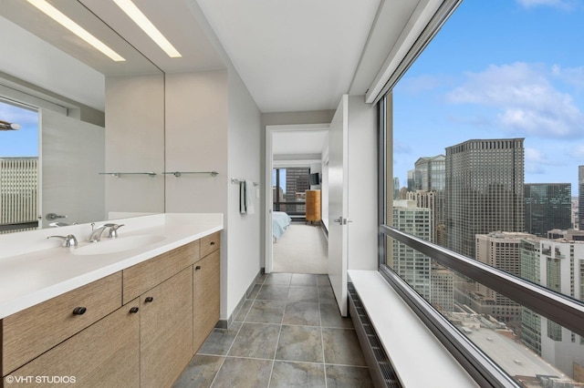 130 N Garland Ct Unit 4101, Chicago, IL 60602 - bathroom featuring vanity, baseboards, and a view of city
