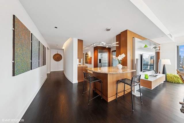 130 N Garland Ct Unit 4101, Chicago, IL 60602 - kitchen with dark wood-type flooring, a breakfast bar area, brown cabinets, and stainless steel built in refrigerator