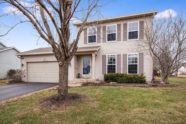 view of front facade with a garage and a front lawn