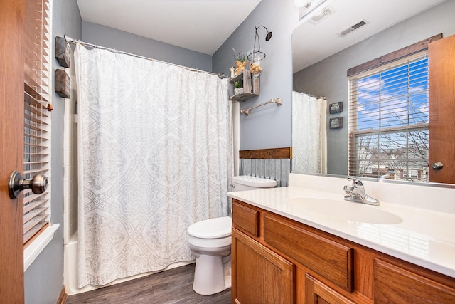 full bathroom with hardwood / wood-style flooring, vanity, toilet, and shower / bath combo