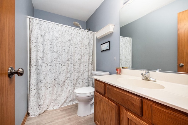 bathroom featuring vanity, toilet, and hardwood / wood-style floors