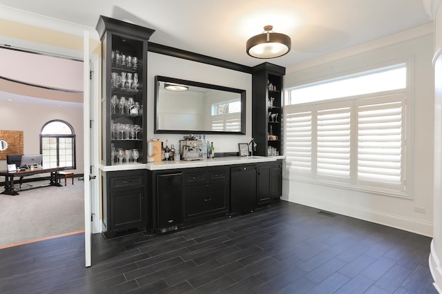 bar with crown molding and dark hardwood / wood-style floors