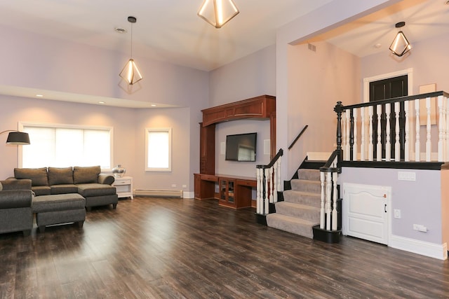 living room with dark hardwood / wood-style flooring, a towering ceiling, and baseboard heating