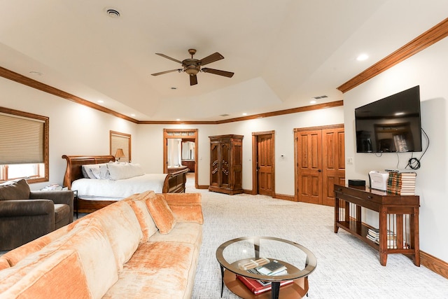 carpeted living room with ornamental molding, a raised ceiling, and ceiling fan