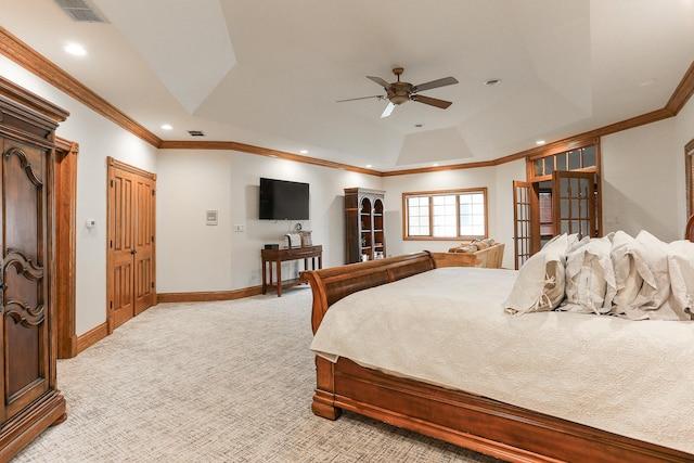 bedroom featuring ornamental molding, light colored carpet, ceiling fan, and a tray ceiling