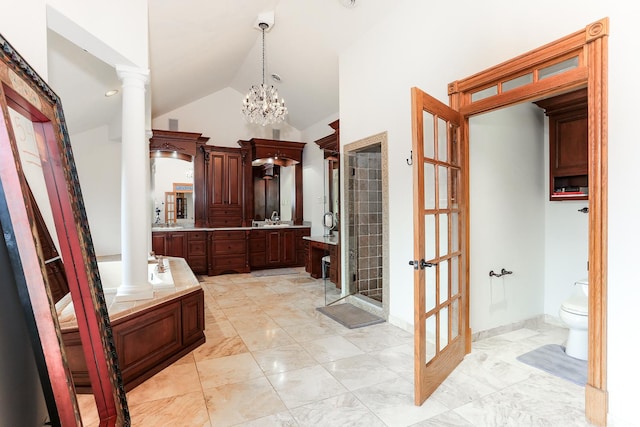 full bathroom featuring ornate columns, vaulted ceiling, separate shower and tub, and vanity