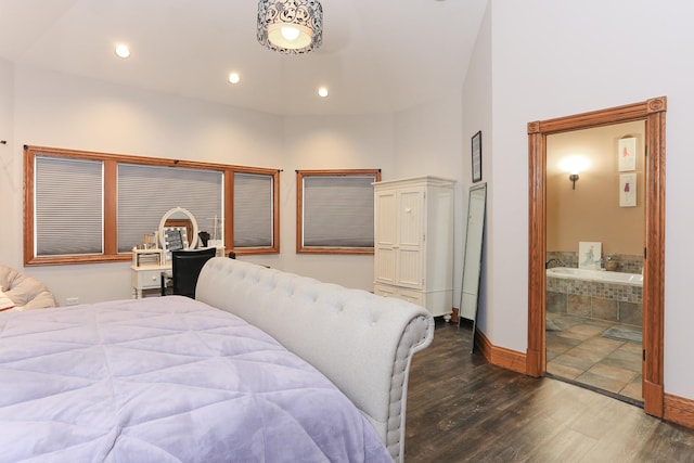 bedroom with dark hardwood / wood-style floors and connected bathroom