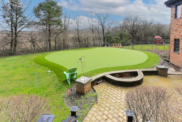 surrounding community with a playground and a patio area