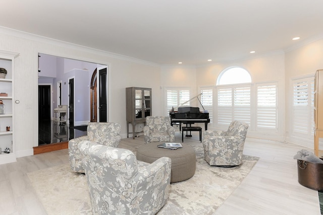 living room with ornamental molding and light wood-type flooring