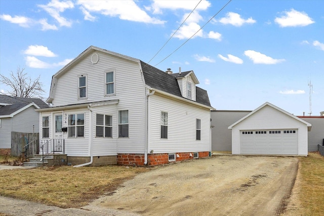 view of front facade featuring an outbuilding and a garage