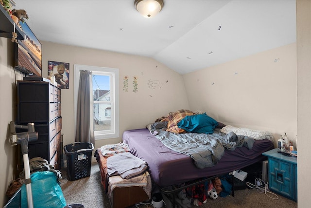 bedroom featuring vaulted ceiling and carpet floors