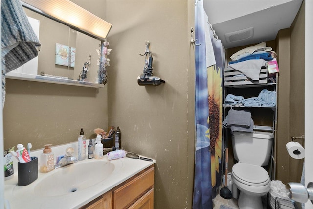 bathroom featuring vanity and toilet