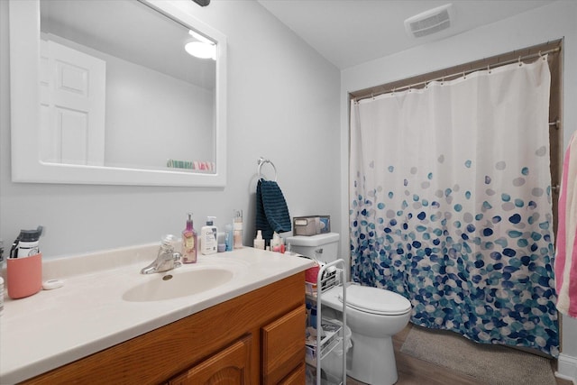 bathroom featuring vanity, toilet, a shower with shower curtain, and hardwood / wood-style floors